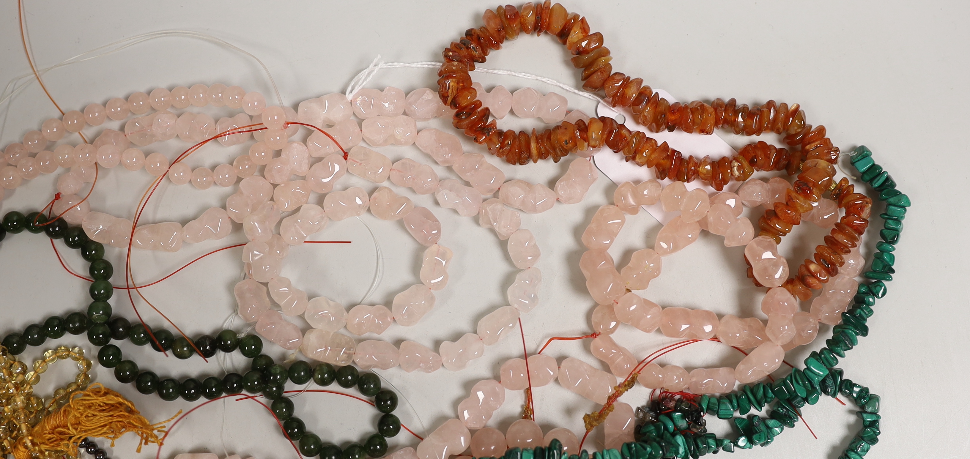 Assorted necklaces including malachite, agate and pink quartz.